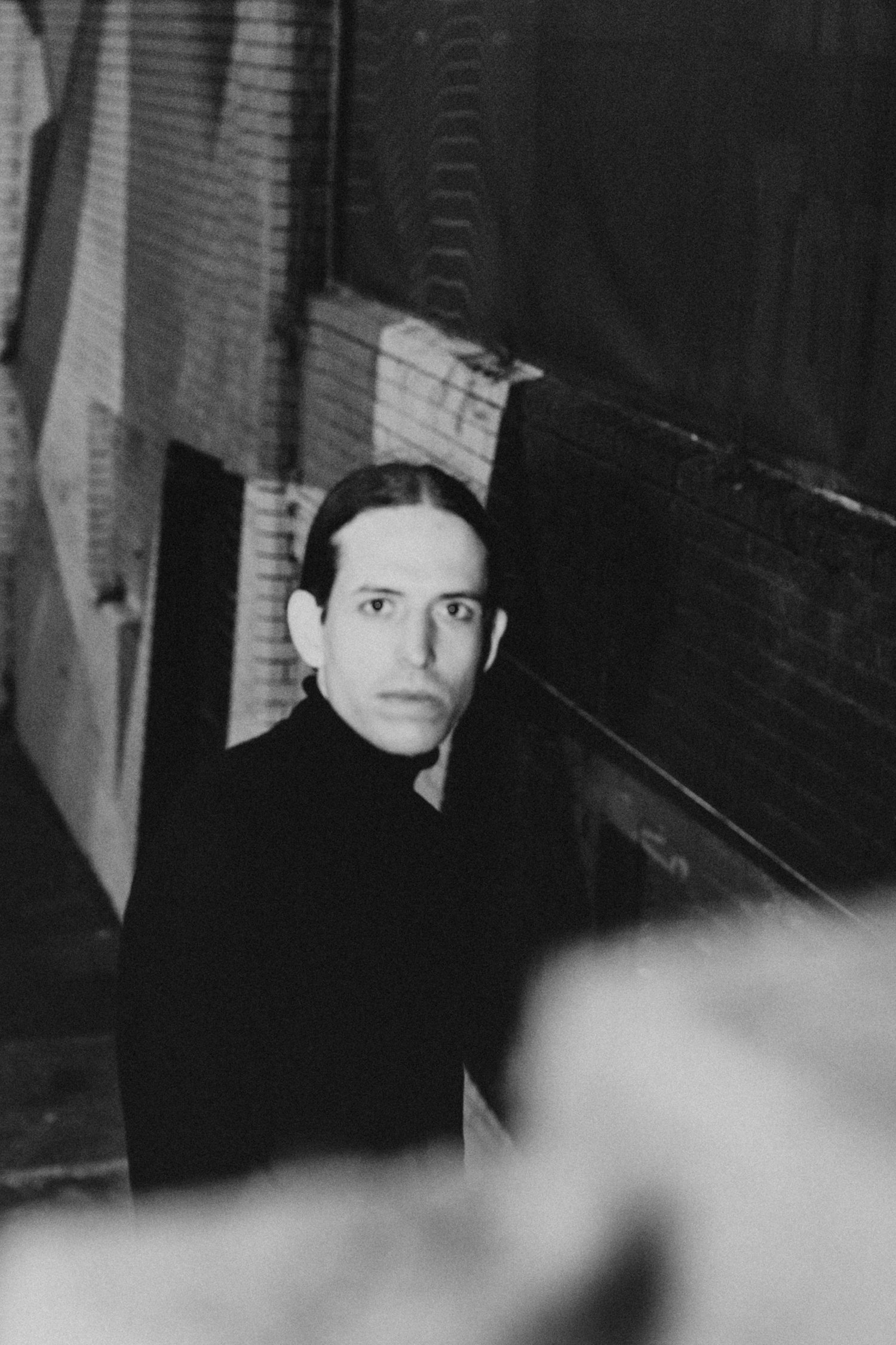 Sebastian Graysen at night on a stairway, looking back toward the camera